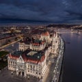 Budapes, Hungary - Aerial drone view of the beautiful illuminated Parliament of Hungary at blue hour with Szechenyi Chain Bridge Royalty Free Stock Photo