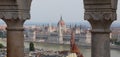 Budapest, B, Hungary - August 18, 2023: Hungarian Parliament building and Danube River between columns