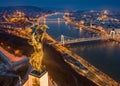 Budapest, Hungary - Aerial blue hour view of illuminated Statue of Liberty with Elisabeth Bridge, Buda Castle Royal Palace