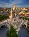 Budapest, Hungary - Aerial view of the famous Fisherman`s Bastion at sunset with Parliament building at background