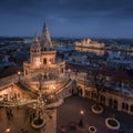 Budapest, Hungary - Aerial view of the famous illuminated Fisherman`s Bastion Halaszbastya with Parliament of Hungary Royalty Free Stock Photo