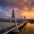 Budapest, Hungary - Aerial view of Megyeri Bridge over River Danube with beautiful golden sky and clouds and heavy traffic Royalty Free Stock Photo