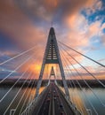 Budapest, Hungary - Aerial view of Megyeri Bridge over River Danube with beautiful golden sky and clouds