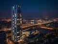 Budapest, Hungary - Aerial night view of MOL Campus skyscraper building with Rakoczi bridge above River Danube