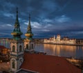 Budapest, Hungary - Aerial view of the Saint Anne Parish Church at Batthyany Square at dusk with illuminated Hungarian Parliament Royalty Free Stock Photo