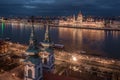 Budapest, Hungary - Aerial view of the Saint Anne Parish Church at Batthyany Square at dusk with illuminated Hungarian Parliament Royalty Free Stock Photo