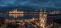 Budapest, Hungary - Aerial view of the Saint Anne Parish Church at Batthyany Square at dusk with illuminated Hungarian Parliament Royalty Free Stock Photo