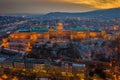 Budapest, Hungary - Aerial view of the snowy Buda Castle Royal Palace with beautiful golden sunset