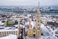 Budapest, Hungary - Aerial view of snowy Matthias Church and Fisherman`s Bastion with Parliament of Hungary Royalty Free Stock Photo