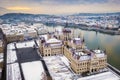 Budapest, Hungary - Aerial view of the snowy Parliament of Hungary with Szechenyi Chain Bridge, Buda Castle Royal Palace Royalty Free Stock Photo