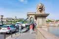 Budapest, Hungary - April 2019: Lion of Chain bridge with Royal palace at background Royalty Free Stock Photo