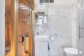 Budapest, Hungary - April 19, 2018: Private home sauna inside a white luxurious marble bathroom in an Airbnb accommodation Royalty Free Stock Photo