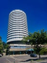 Tall round hotel building with the name Budapest against the backdrop of a blue sky and sunny weather