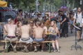 Happy young guys and girls are sitting in a cafe during the music festival Sziget in Budapest, Hungary. Royalty Free Stock Photo