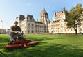 Budapest, Hungari - August 29, 2017: Worker mowing grass near Hungarian Parliament Building in Budapest. Royalty Free Stock Photo