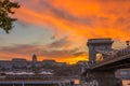 Budapest, Hungary - Beautiful dramatic golden sunset at Szechenyi Chain Bridge with Buda Castle Royal Palace Royalty Free Stock Photo