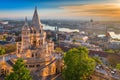 Budapest, Hungary - Beautiful golden summer sunrise with the tower of Fisherman`s Bastion and green trees. Parliament of Hungary Royalty Free Stock Photo