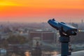Budapest, Hungary - Blue binoculars with the view of Pest with Szechenyi Chain Bridge and beautiful golden sky Royalty Free Stock Photo