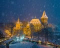 Budapest, Hungary - Christmas market in snowy City Park Varosliget from above at night with snowy trees