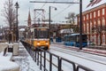 BUDAPEST, HUNGARY - DECEMBER 02, 2019: Yellow tram and tramlines in Budapest at winter with snow near the embankment on Royalty Free Stock Photo