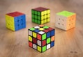 Budapest, Hungary; 9 february 2019: Several Rubik cubes intelligence toys unsolved, in a wood table