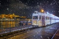 Budapest, Hungary - Festively decorated light tram fenyvillamos on the move with Buda Castle Royal Palace