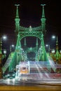 Budapest, Hungary - Festively decorated light tram fenyvillamos on the move at Liberty Bridge Szabadsag hid by night