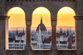 Budapest, Hungary - The Hungarian Parliament building at sunrise looking through old stone windows