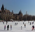 Budapest, Hungary - 02/19/2018: ice rink with people against old castle in Varoshelighet park. Winter sport and fun.