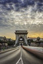 Budapest, Hungary - The iconic Szechenyi Chain Bridge at sunset with amazing sky Royalty Free Stock Photo