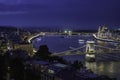 Budapest, Hungary - Illuminated Szechenyi Chain Bridge on a night photograph with Parliament of Hungary Royalty Free Stock Photo