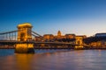 Budapest, Hungary - Illuminated Szechenyi Chain Bridge over River Danube and Buda Castle Royal Palace Royalty Free Stock Photo
