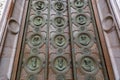 Medallions on wooden door showing busts of the 12 apostles at St. Stephen`s Basilica in Budapest, Hungary