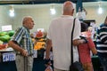 Budapest / Hungary - July 29 2019: Retired old men shopping in local market holding watermelon. Elderly customer at marketplace