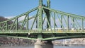 Budapest, Hungary. The Liberty Bridge or Freedom Bridge across the river Danube. Yellow tram is riding on the bridge Royalty Free Stock Photo