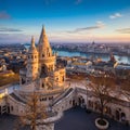 Budapest, Hungary - The main tower of the famous Fisherman`s Bastion Halaszbastya from above with Parliament Royalty Free Stock Photo