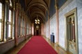 BUDAPEST, HUNGARY - 03 MAR 2019: Long hallway with red carpet on marble floor and chandelier on the ceiling in the