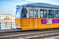 BUDAPEST, HUNGARY - MARCH 30, 2019: Old yellow tram speeds up along city streets. The historical center of the capital of Hungary Royalty Free Stock Photo