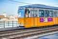 BUDAPEST, HUNGARY - MARCH 30, 2019: Old yellow tram speeds up along city streets. The historical center of the capital of Hungary Royalty Free Stock Photo