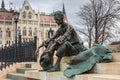 Sitting Statue of poet Attila Jozsef, on the background Hungarian Parliament Building, Budapest