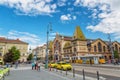 BUDAPEST, HUNGARY - MAY 2017: Central Market Hall in Budapest city, Hungary, Europe. Pedestrian crossing and yellow tram, taxi in Royalty Free Stock Photo