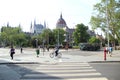 Crossroads and crosswalks with people and vehicles with the Hungarian Parliament
