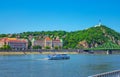 Budapest spring cityscape with Danube River, historic Gellert Hotel building and touristic boat Royalty Free Stock Photo