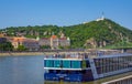 Budapest spring cityscape with Danube River, historic Gellert Hotel building and touristic boat Royalty Free Stock Photo