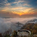 Budapest, Hungary - Mysterious foggy sunrise with Liberty Bridge Szabadsag hid and lookout on Gellert Hill Royalty Free Stock Photo