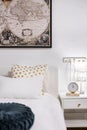 Budapest, Hungary - November 15, 2019: Detail shot of white theme bedroom with golden dotted pillow, white headboard and world map