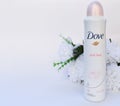 Dove soft feel deodorant with flower on white background.