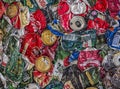Recycled aluminum beverage cans of various drink brands screwed to wall. Garbage recycling Royalty Free Stock Photo