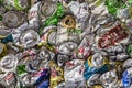 Budapest, Hungary - October 10, 2019: Recycled aluminum beverage cans of various drink brands screwed to wall. Garbage recycling