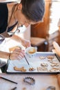 Budapest, Hungary - October 19, 2109: Tradittional home-made gingerbread baking. Egg brushing the ginger dough cut-outs